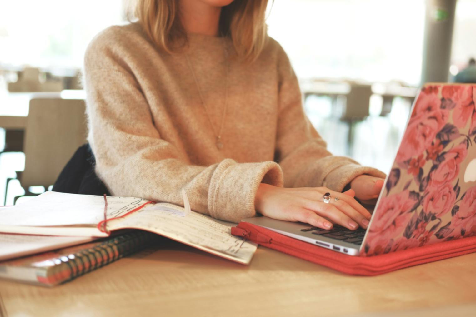 Person reviewing financial charts and investment portfolio on laptop